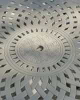 Close up of the lattice and ornate pattern on the table.
