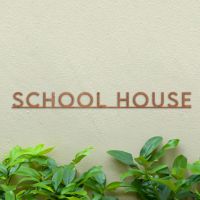 Minimalist Rustic House Name Sign on Green Wall