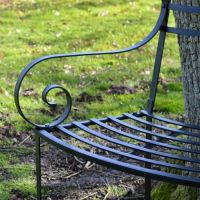 Close-up of the Ornate Scroll Arms on the Tree Seat