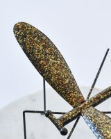 Close up of wings and body detail on recycled metal art sculpture