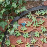 Close-Up of Black Circular Frame on Garden Wall Art