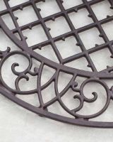 Close-Up of Cast Iron Structure on Arched Doormat