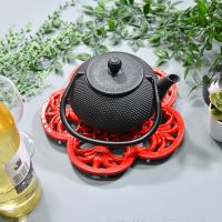 Red Cast Iron Flower Petal Trivet in Use with Teapot