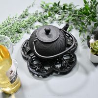 Black Cast Iron Flower Trivet in Use with Teapot