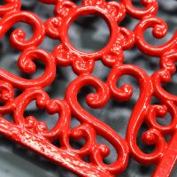 Red Cast Iron Square Trivet Close-Up