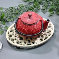 Cream Cast Iron Oval Trivet in Use with Teapot