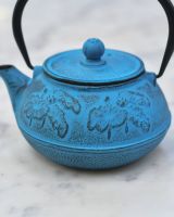 Close up of "Oketo" Lotus Flower Blue and Black Cast Iron Japanese Style Teapot embossed detailing