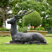 Side view of Cast Iron Black Stag Sculpture sitting down