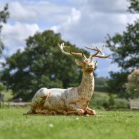 Cast Iron Rustic Cream Stag Sculpture in Garden Setting