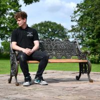 Aged Black Cast Iron Garden Bench with Male for Scale