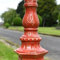 Ornate detailing on red lamp post