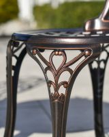 Close-up of the Antique Bronze Finish on the Chairs of the Dining Set