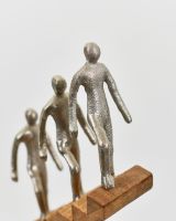 Close up of silver aluminium people detail on home interior sculpture