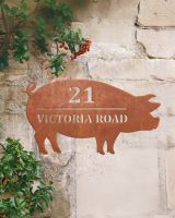 Pig Corten Steel House Name Sign Mounted on a Rustic Sandstone Wall