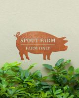 Pig Corten Steel House Name Sign in Situ on a Painted House Wall
