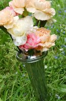 Aluminium conical vase in use in graveyard