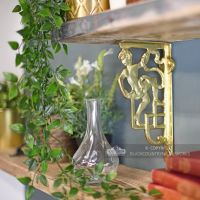 Polished brass cherub shelf bracket