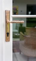 Polished Copper Hammered Slimline Lever Door Handle on Door