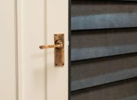 Polished Copper Lever Latch Door Handle on Door