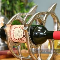 Side View of a Wine Bottle Being Held in the wine Rack