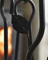 Close up of intricate leaf detailing on fireside companion set