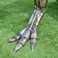 Feet on the Recycled Metal T-Rex Sculpture