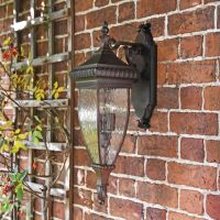 Renaissance Style Standard Hanging Bronze Wall Lantern Mounted on a Brick Wall