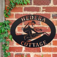 Roofer Iron Oval House Sign on a Brick Wall