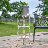 "Rose" Aged Rustic Cream Cast Iron Side Stand Holding a Plant Pot in the Garden