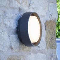 Round Wall Light in a Anthracite Finish in Situ on a Stone Wall