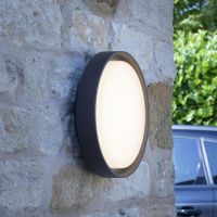 Round Wall Light in a Anthracite Finish in Situ on a Stone Wall