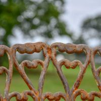 Close up of rustic finish on heart scrolled chair