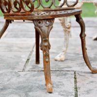 Close up of rustic finish on scrolled chair