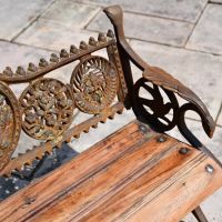 Close up of Rustic Cast Iron Garden Bench with Wooden Slats 