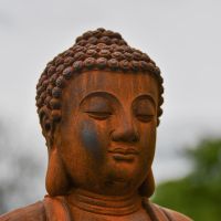 Close-up of the Face on the Rustic Cast Iron Buddha Sculpture