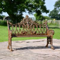 Rustic Cast Iron Gothic Two Seat Bench in Use on a Garden Patio