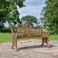 Rustic Cast Iron Gothic Two Seat Bench in Use in the Garden