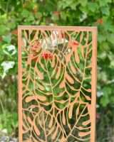 Close up of intricate cut out detail on rustic garden screen