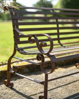 Close-Up of Armrest for Rustic Wrought Iron “Chatham" Two Seater Garden Bench