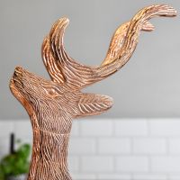 Close up of detailing on copper stag wine rack