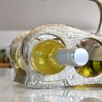 Close up of circular holder with wine bottle 
