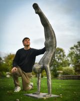 Scale image of handstanding figure art sculpture