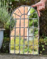 Scale image of metal garden mirror