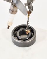 Close up of Spark Plug Hummingbird Recycled Metal Ornament base