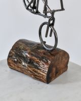 Close up of Cyclist Stoppie Recycled Metal Ornament base