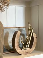 Angled back view of aluminium and mango wood art sculpture
