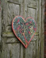 Side view of colourful steel overlay garden mirror wall art