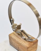 Top view of person reading in home decor sculpture