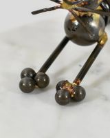 Close up of intricate paw detail on recycled metal art sculpture