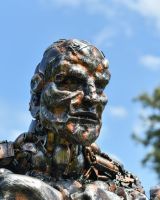 Close up of face detail on recycled metal art sculpture
